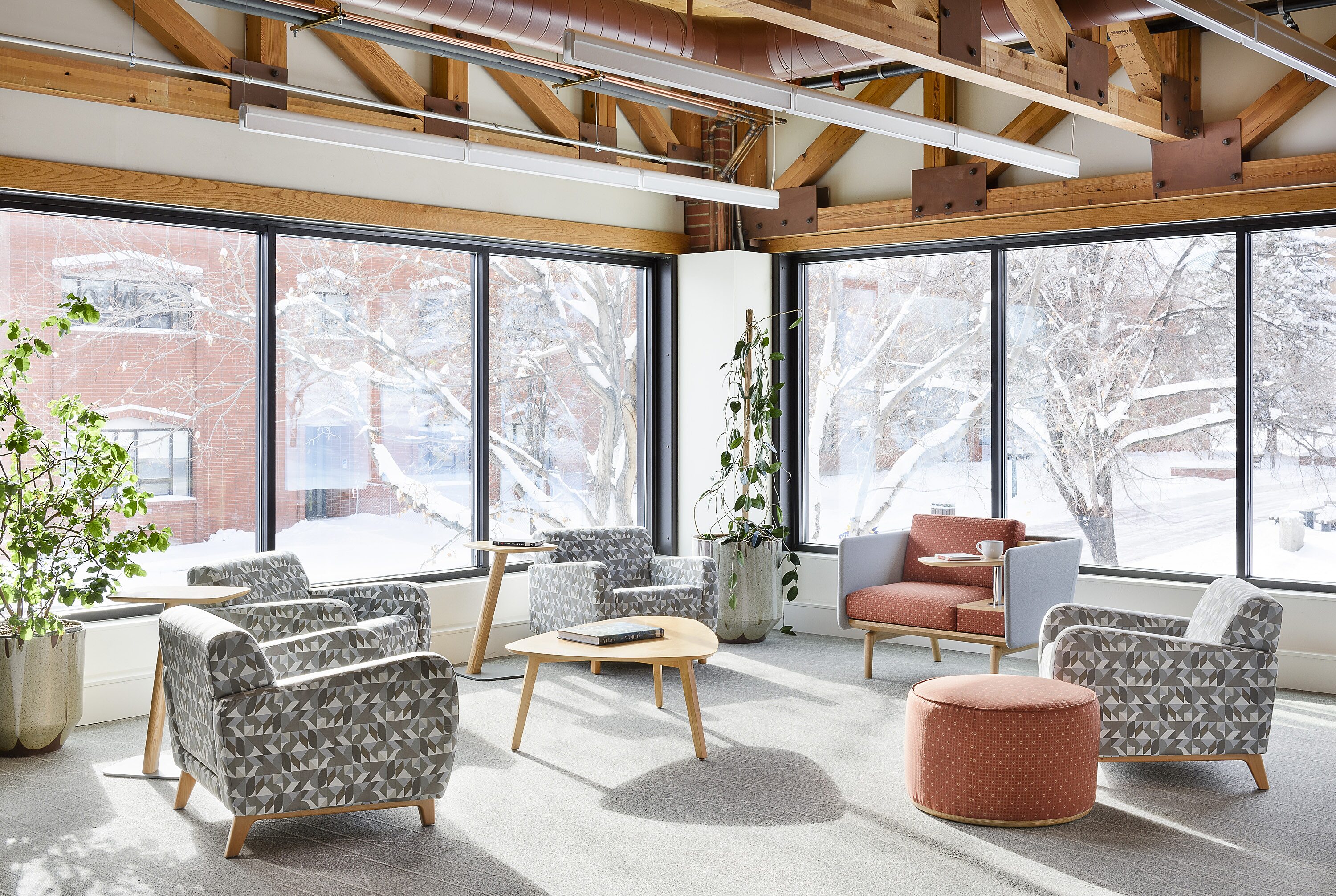 Light and bright sitting area with colorful chairs and side tables.